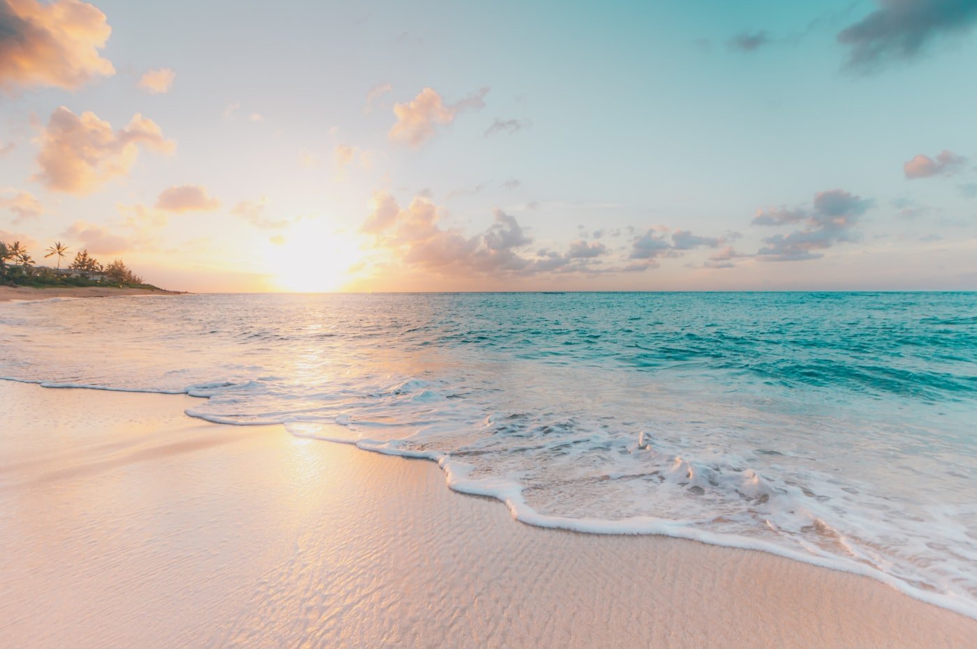 A calm coastal shoreline at golden hour